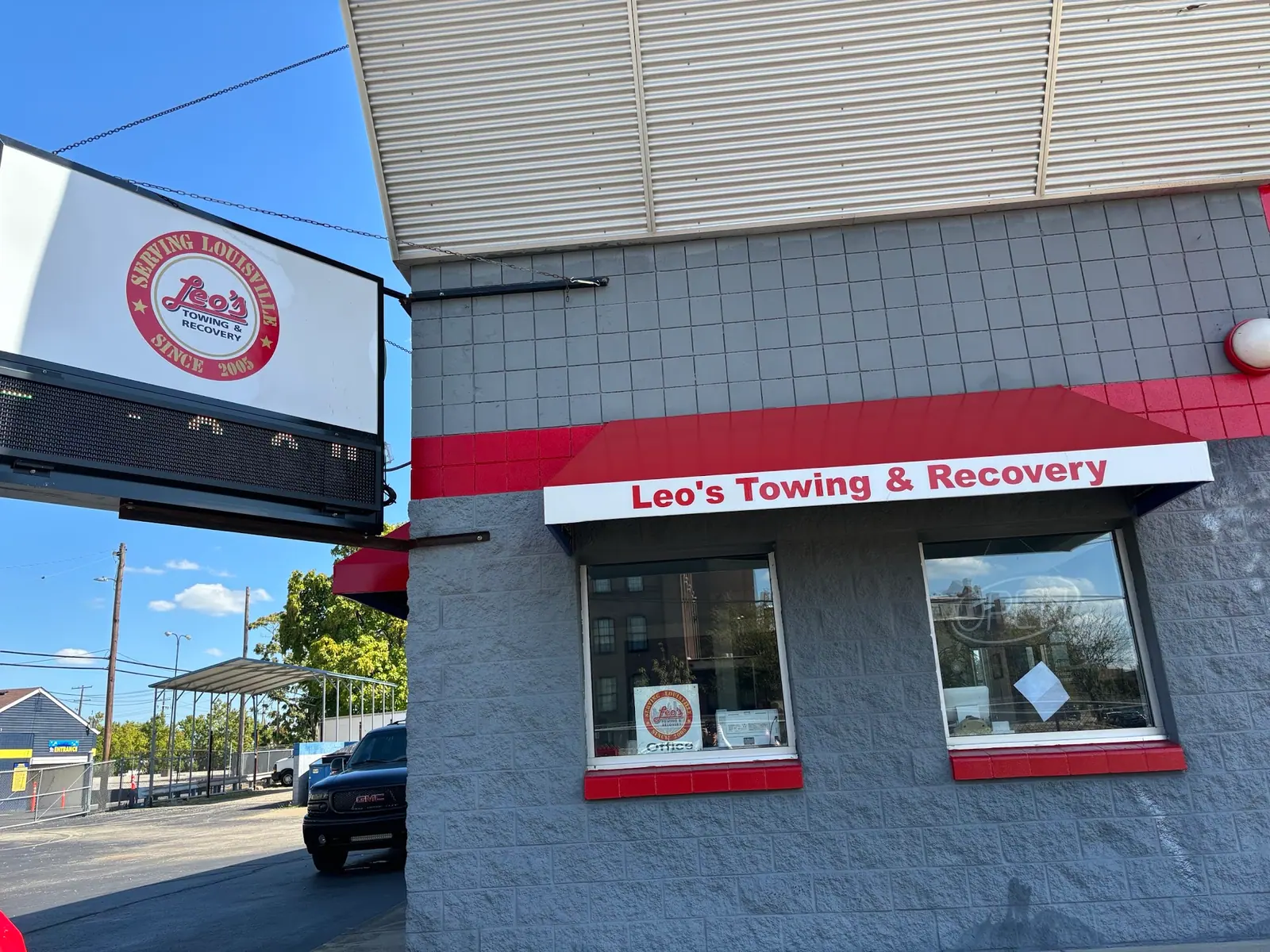 Leo's Towing & Recovery storefront and hanging sign