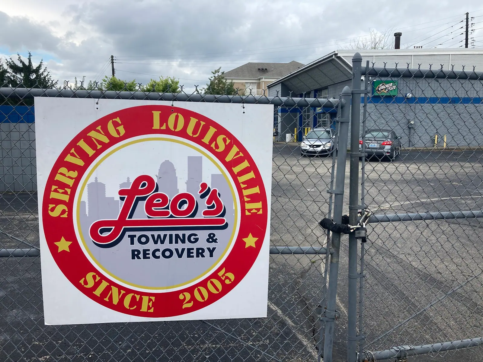 Leo's round Serving Louisville since 2005 sign on the yard gate